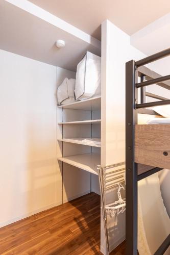 a bedroom with a bunk bed and wooden floors at Flex cella Tsukisamu in Sapporo