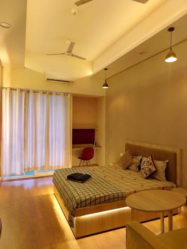 a bedroom with a bed and a table and a window at Singh comfy stay in Ghaziabad