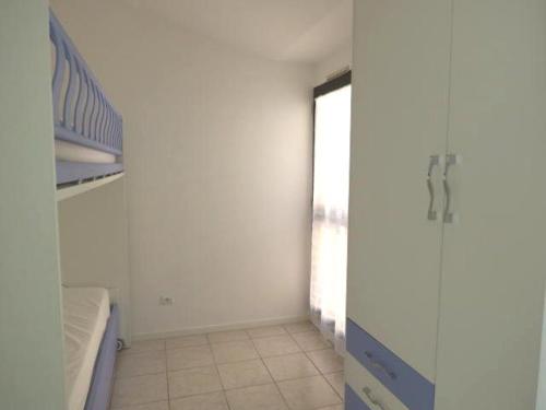 une chambre blanche avec un lit et une fenêtre dans l'établissement Appartement 3 pièces avec piscine et climatisation à Sainte-Maxime - FR-1-780-62, à Sainte-Maxime
