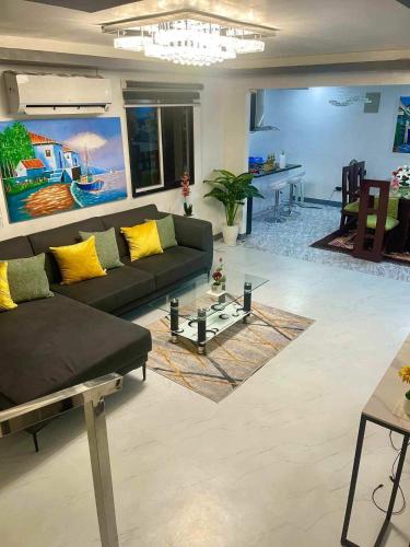 a living room with a couch and a table at Cai Âirbnb - An affordable comfortable hideout with fully AC in Santa Rosa
