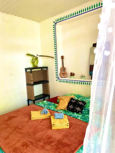 a bedroom with a bed with towels and a mirror at rent room papeete in Papeete