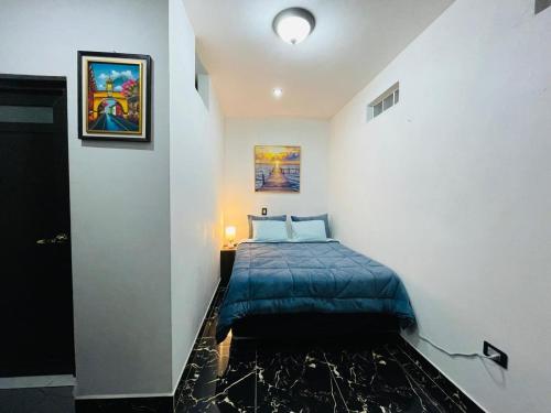 a bedroom with a bed in a white wall at casa borde de lago in Panajachel