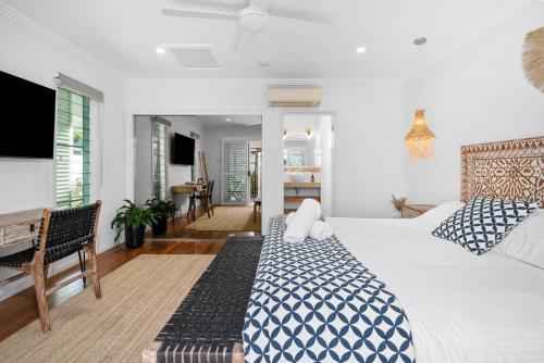 a bedroom with a bed and a living room at Azur Byron Bay in Byron Bay