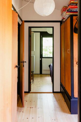 a hallway with a door open to a room at Birdsong And The Sound Of Waves At Reersø in Gørlev