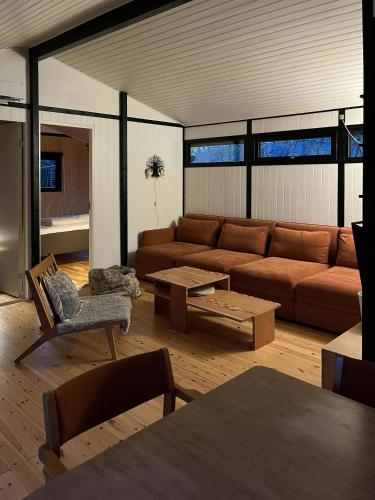 a living room with a couch and a table at Birdsong And The Sound Of Waves At Reersø in Gørlev
