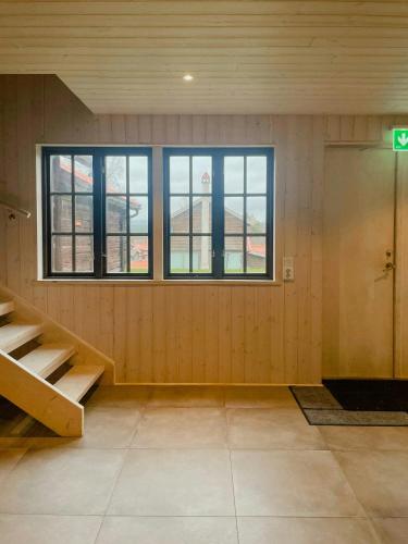 an empty room with a door and windows at Active Holiday In Dalarnas Gopshus in Blyberg
