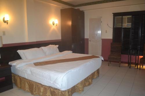 a bedroom with a large bed in a room at DM Residente Hotel Inns & Villas in Angeles