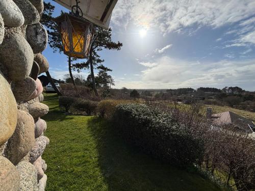 a street light on the side of a stone wall at Cozy Holiday Home With Sea Views in Nykøbing Sjælland