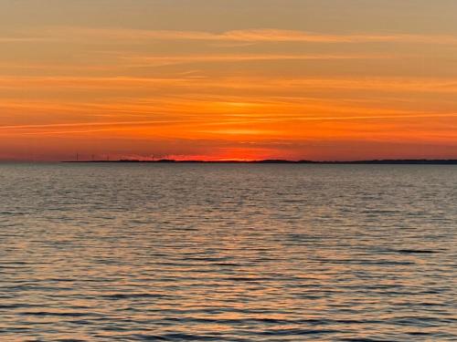 a sunset over a body of water at Quiet In House By The South Funen Archipelago in Humble