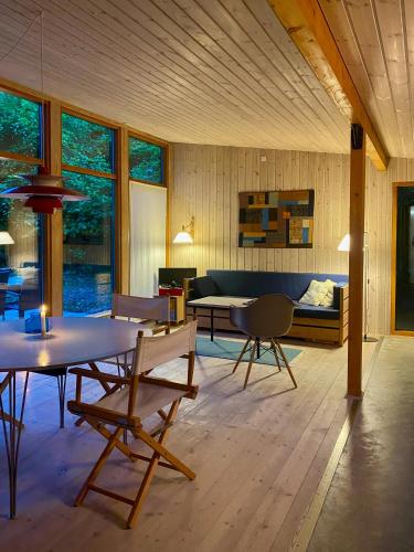 a living room with a couch and a table at Architect-Designed Wooden House In Tisvilde Lunde in Tisvildeleje