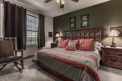 a bedroom with a large bed and a chair at Cozy Retreat 2BR Condo with Jacuzzi & Indoor Pool in Pigeon Forge