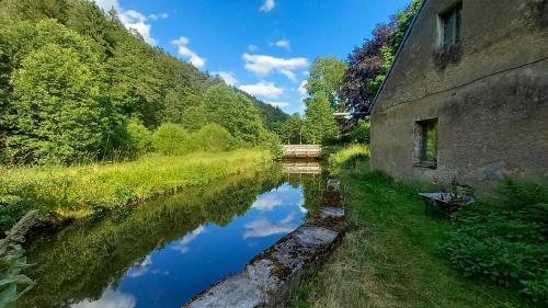 a river next to a building next to a building at Design Apartment In The Historic Mittermurnthal in Neunburg vorm Wald