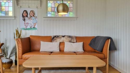 a couch in a living room with a dog laying on it at Holiday Home Idyll By Roskilde Fjord in Kirke-Hyllinge