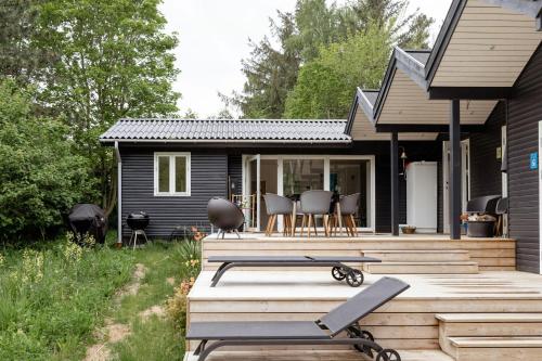 a house with a deck with chairs on it at Architect-Designed Home With Outdoor Space in Hundested