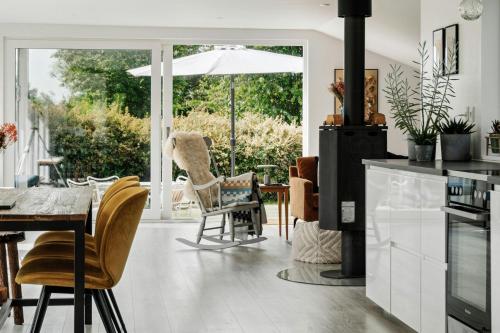 a kitchen with a dining area with a table and chairs at Beautiful Tranquil Home By Fjord Near Copenhagen in Holbæk