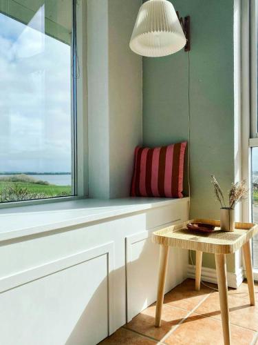 a window seat with a bench and a table at Summer House With Panoramic View Near Doverodde in Doverodde