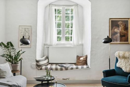 a living room with a window and a couch at Unique Stay At Odden Manor & Museum in Hjørring