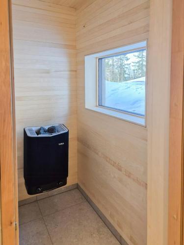 a small room with a window and a trash can at Architect-Designed Cabin At Hallandsfjellet in Rødberg