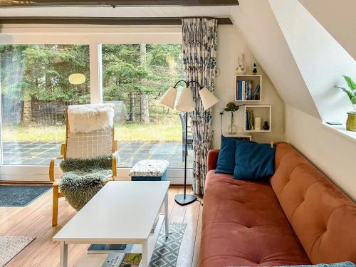 a living room with a couch and a table at Summerhouse By The North Sea in Vestervig