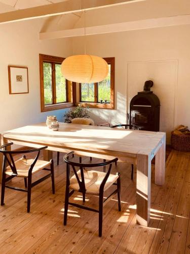 a dining room with a table and two chairs at Historic House South Of Copenhagen in Borup