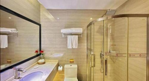 a bathroom with a shower and a sink and a toilet at Auspicious Hotel in Zhongshan