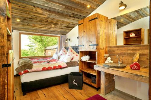 a bedroom with a bed and a sink in a room at Cabin In The Nature Of Bavaria in Schöllnach
