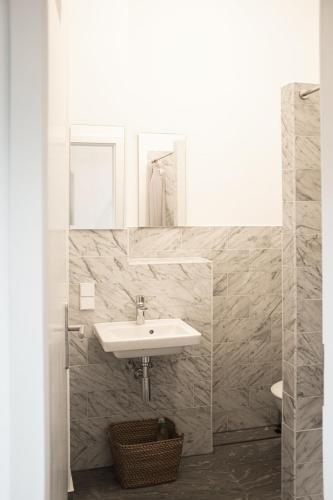 a white bathroom with a sink and a mirror at Holiday Apartment In Manor House On Rügen in Poseritz