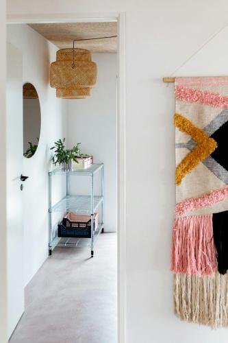 a room with a rug on the wall and a glass shelf at Newly Built Summer House With Sea View in Haderslev