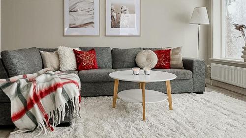 a living room with a couch and a table at Nature Gem With Lake View Near Hudiksvall in Forsa