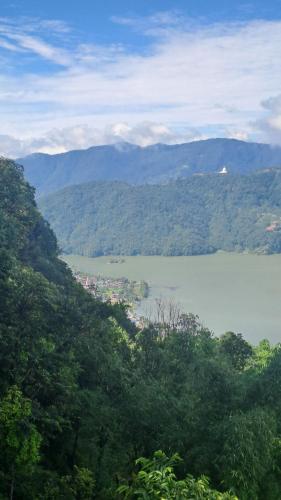 a view of a large body of water with mountains at Kailash villa and restro in Pokhara
