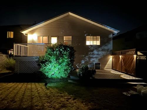 a house at night with a green light at Heavenly Cozy Place Inc in Airdrie