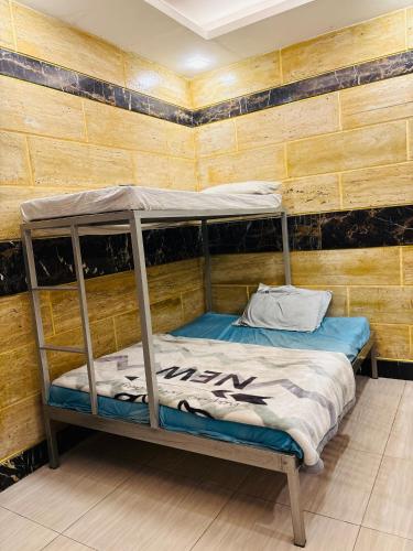 a bunk bed in a room with a wooden wall at Smart Apartment in Gullberg Lahore in Lahore