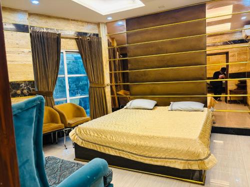 a hotel room with a bed and a chair at Smart Apartment in Gullberg Lahore in Lahore