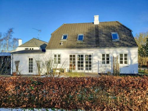 a white house with a gray roof at Country House With Large Garden On Langeland in Humble