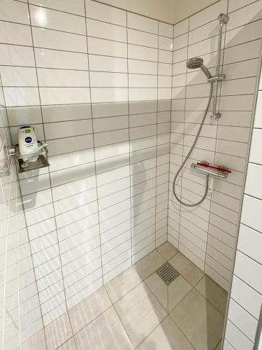 a bathroom with a shower with a glass door at Stunning Sunrises Over Harre Vig in Roslev