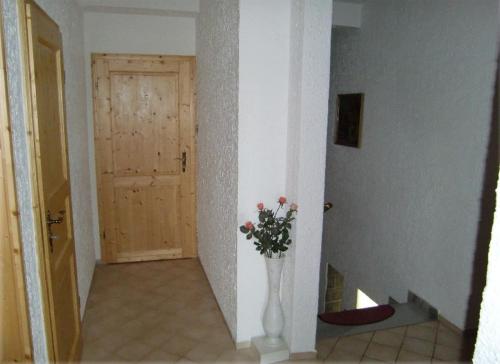 a hallway with a vase with flowers in it at Penzion Buchmann in Františkovy Lázně