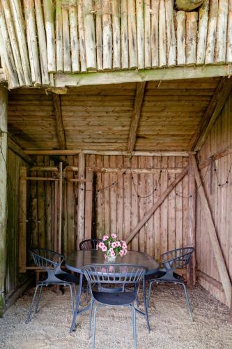 a table and chairs in a wooden shed at Old Stewards Home Surrounded By Nature in Maribo