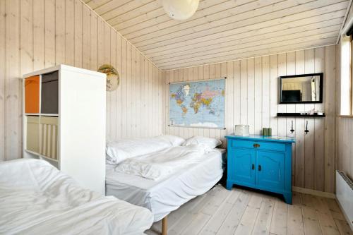 a room with two beds and a blue table at Family Home With Sauna And Fjord View in Børkop
