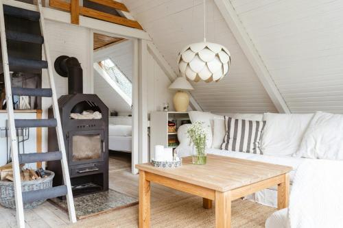 a living room with a couch and a wood stove at Close To Beach, Forest And Bike Trails in Grenå