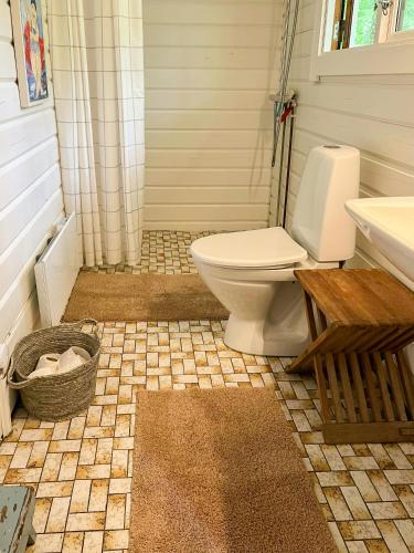 a bathroom with a toilet and a sink at Summerhouse In Forest Near Rørvig Beach in Nykøbing Sjælland