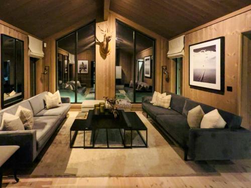 a living room with couches and a coffee table at Modern Cabin By Skeikampen's Ski Trails in Svingvoll