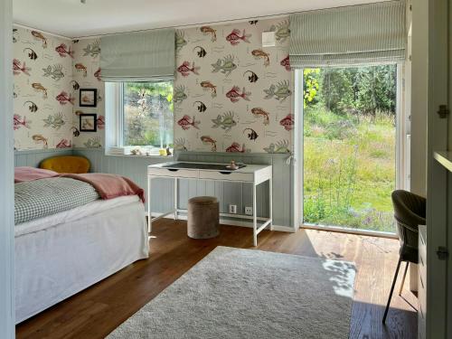 a bedroom with a bed and a desk and a window at Your Archipelago Dream On Ingarö in Värmdö