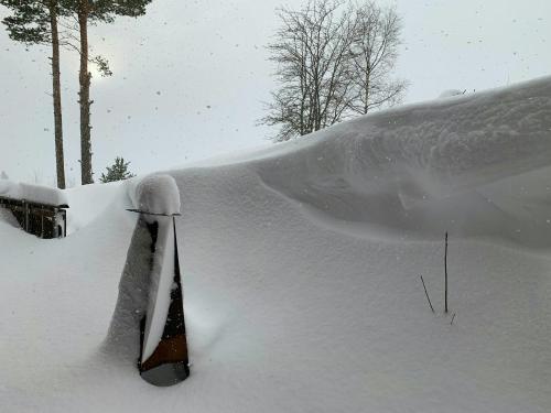 a snow covered car is covered in snow at Countryside Cabin With Jacuzzi Near Stryn in Sølberg