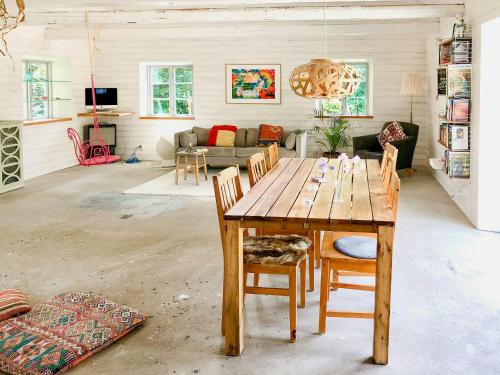 a living room with a wooden table and chairs at Timber-Framed House With Organic Farm In Nature in Stehag