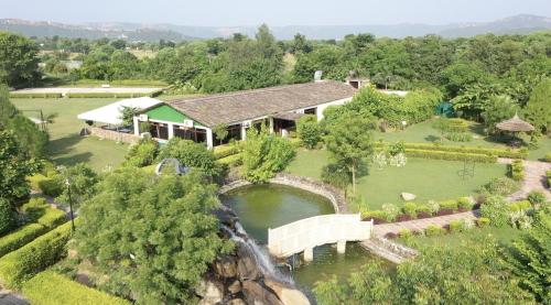an aerial view of a house with a bridge over a river at Astroport Sariska Treetop by Eight Continents in Tehla