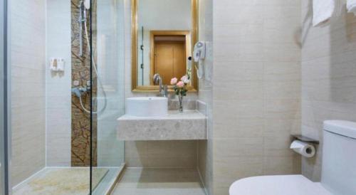 a bathroom with a sink and a shower at Vienna Hotel Guangdong Huidong Herung Pedestrian Street in Huidong