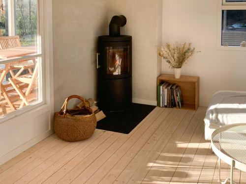 a living room with a wood burning stove in the corner at Charming Cottage Close To Smidstrup Beach in Gilleleje