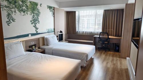 Ένα ή περισσότερα κρεβάτια σε δωμάτιο στο Atour Hotel Hangzhou West Lake Hefang Street