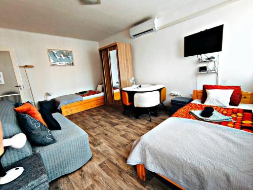 a hotel room with a bed and a couch at 100 lépés - 100 steps - Apt with huge terrace next to the thermal bath in Harkány