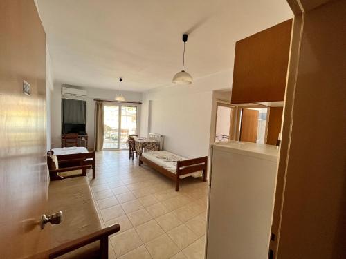 a kitchen and a living room with a refrigerator at Lerna Rooms in Míloi